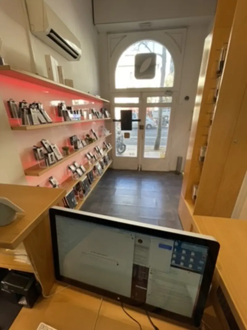 Amit Bhardwaj counter from employee POV — iMac with Airtable open, appointments scheduled